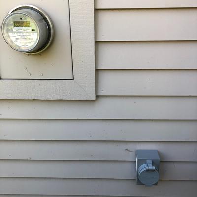Exterior generator inlet box mounted outside a house