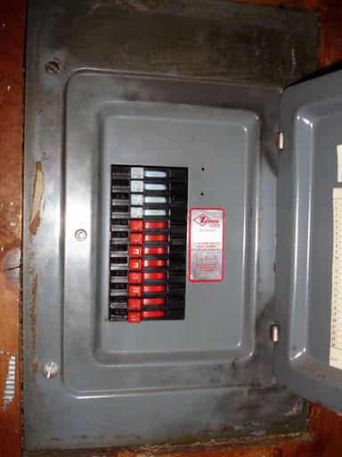 Older Zinsco electrical panel with colored breakers