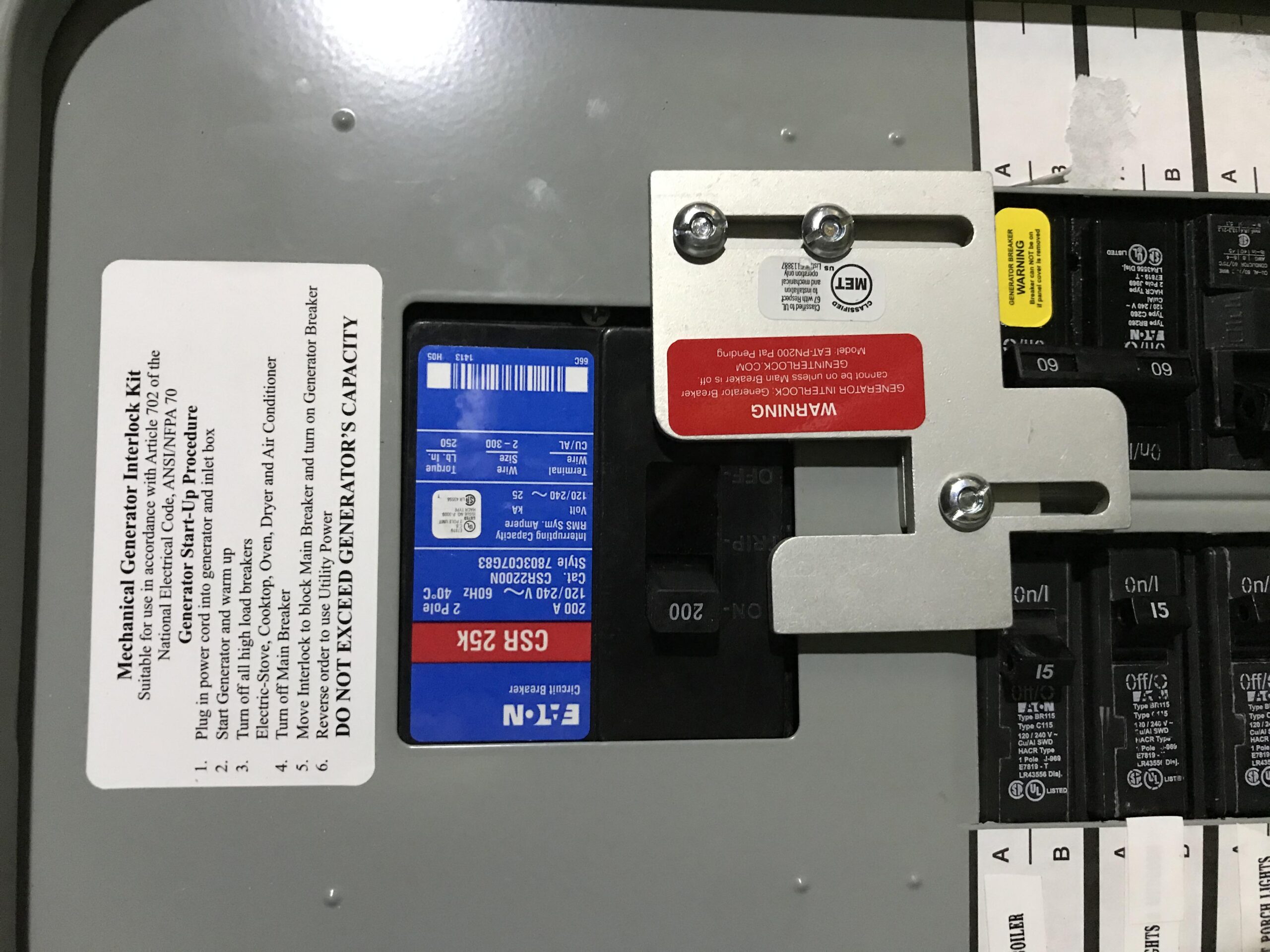 Examples of generator interlock kits installed on breaker panels